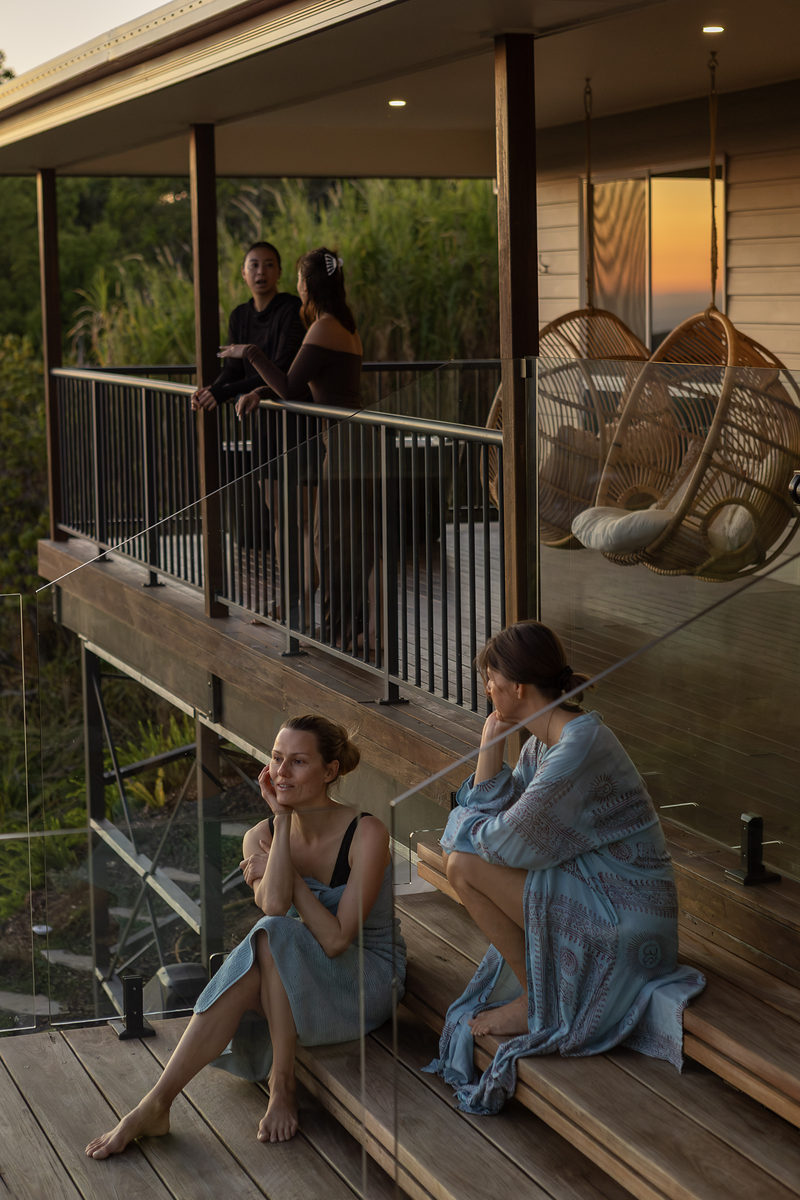 Two guests talking on the deck steps