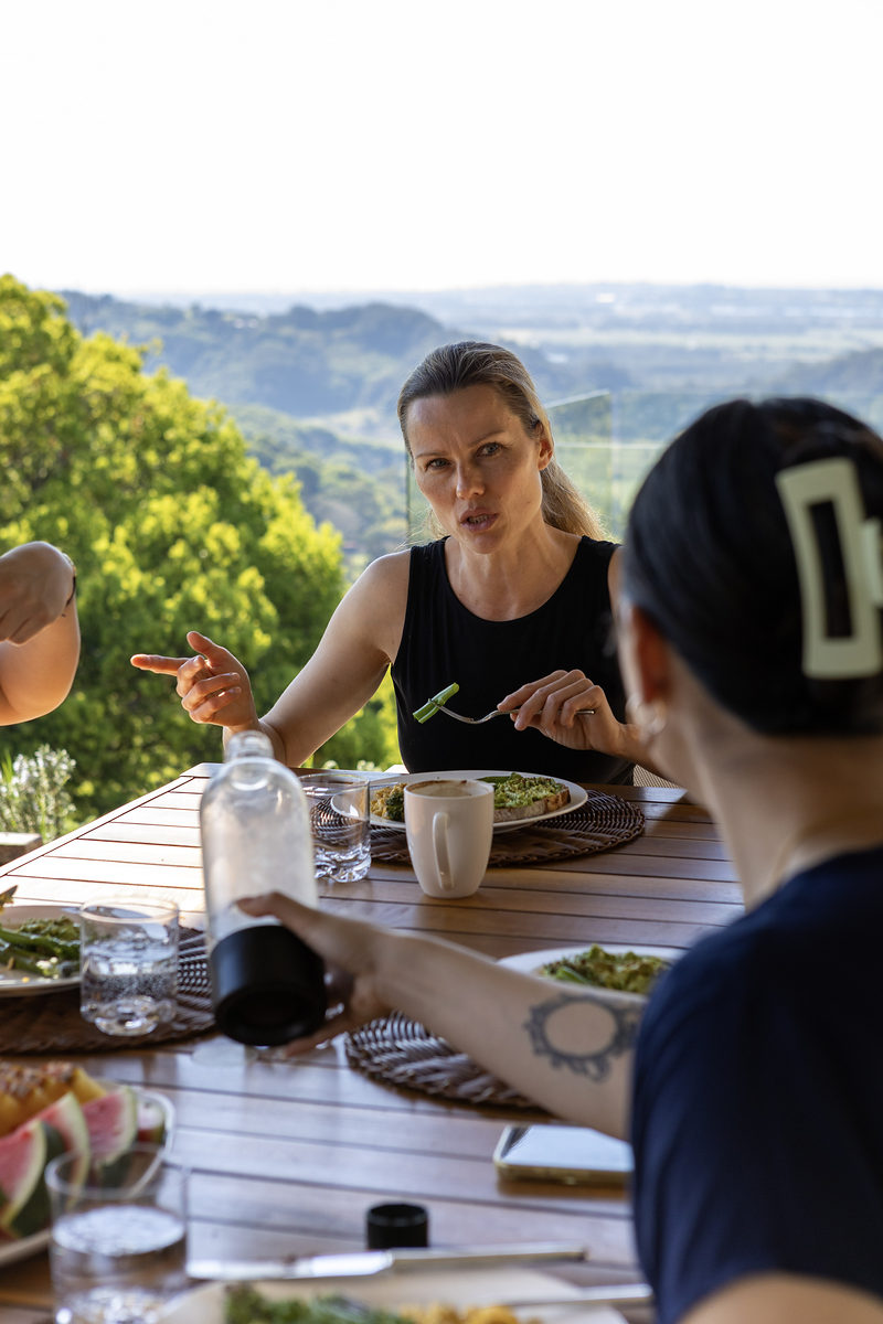 Guests sharing a meal outdoors on the deck
