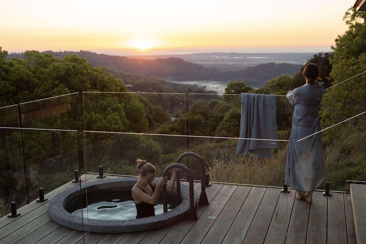 Guests by the plunge pool watching the sun set over the valley