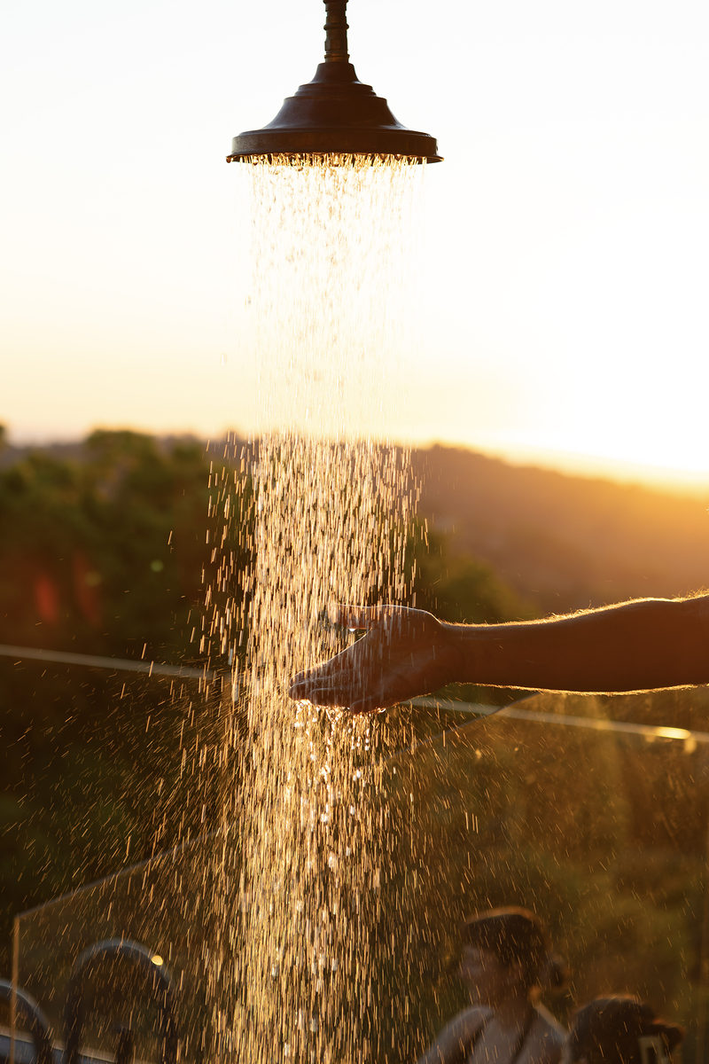 Outdoor shower falling in the golden-hour light