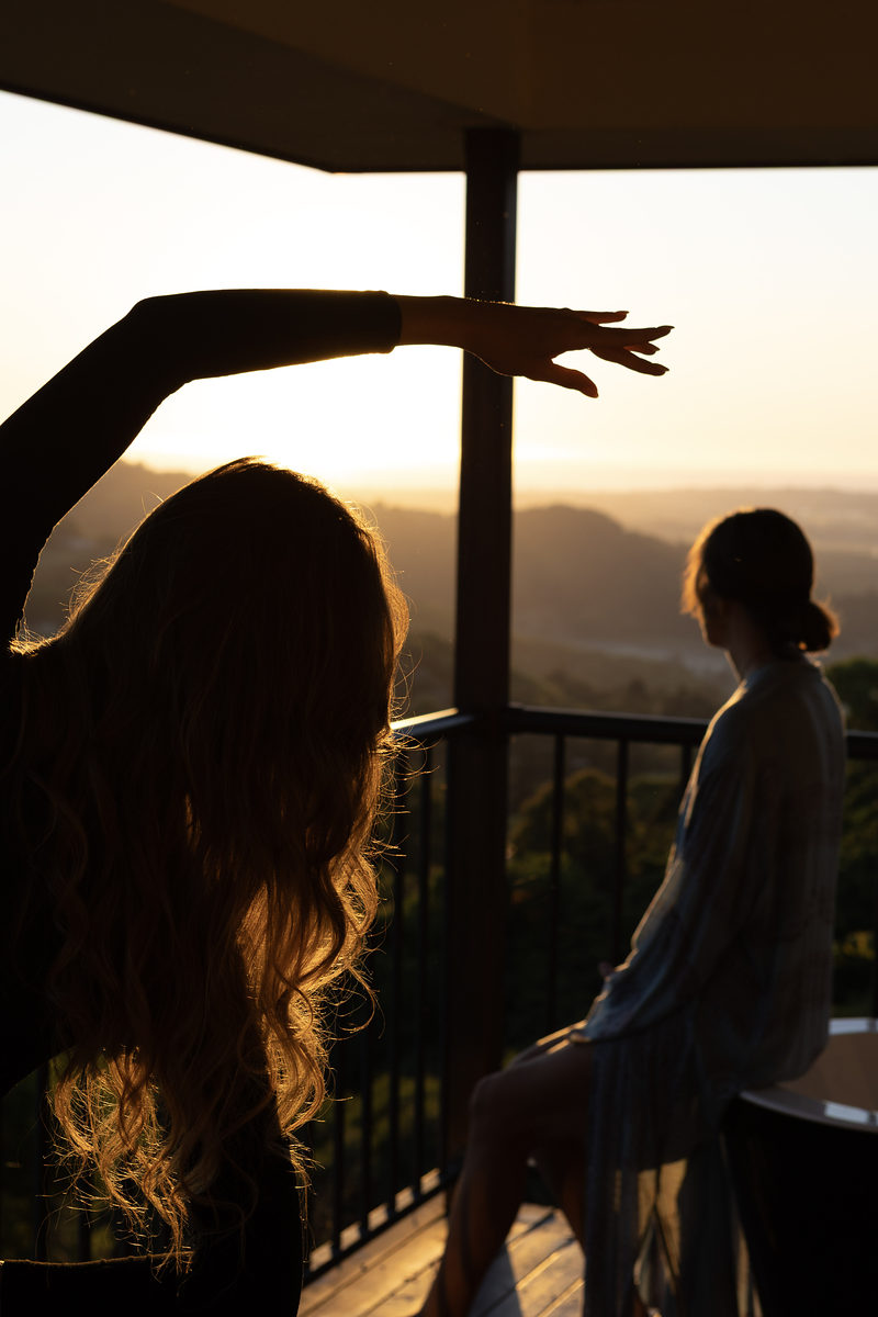 Guests stretching on the deck at sunset