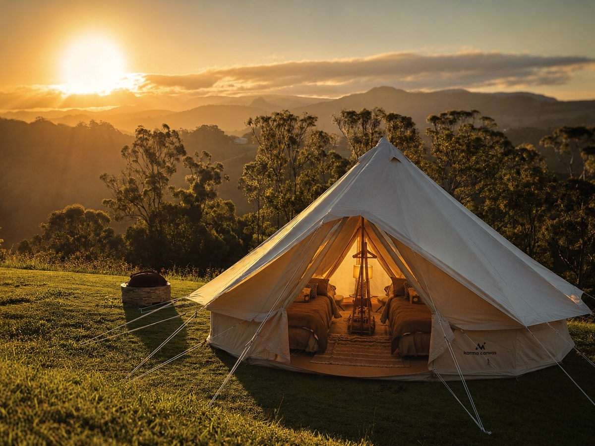 A glamping tent on the lawn at sunset, made up with two beds