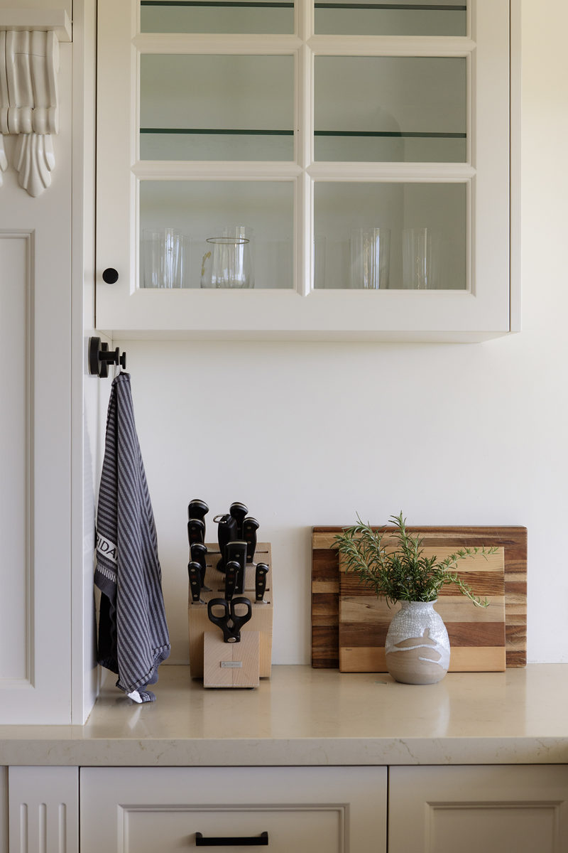 Kitchen corner with glass cabinets and fresh herbs