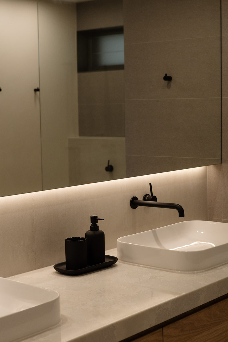 Bathroom vanity with stone benchtop and matte black tapware