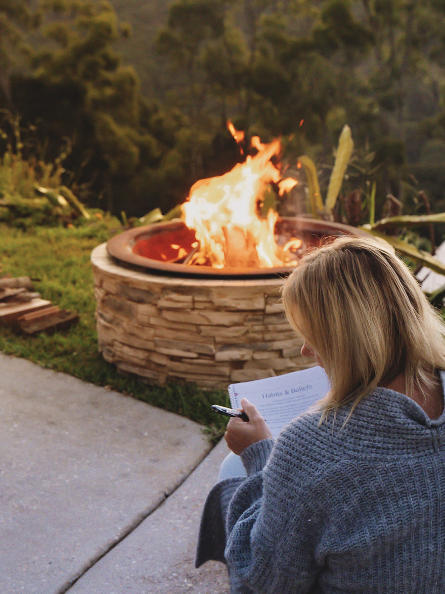 Guest journalling beside the fire pit