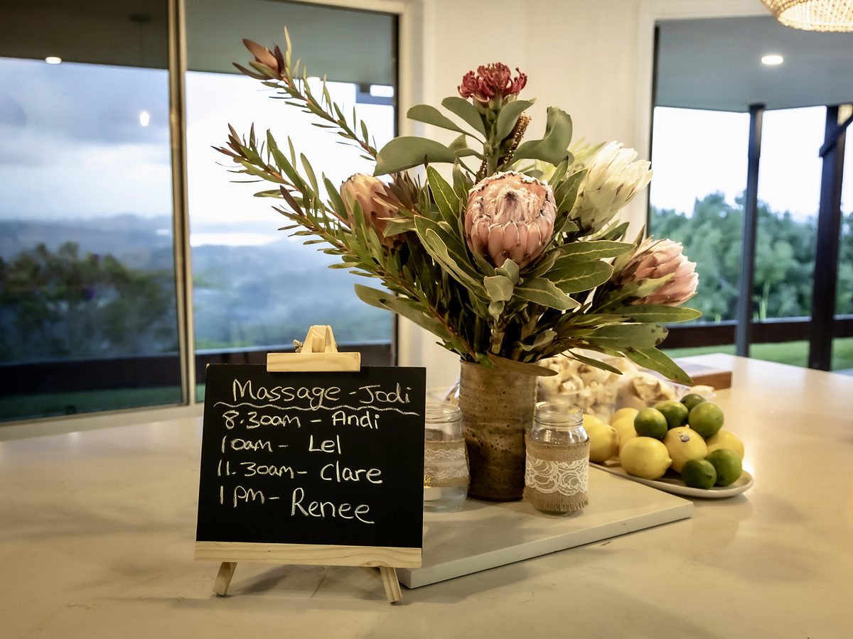 Welcome board and protea flowers on the kitchen bench