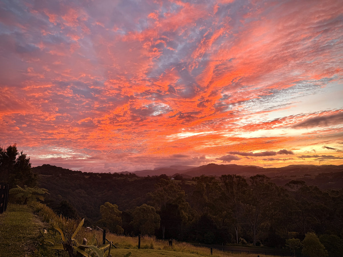 A fiery sunset sky over the hinterland ridgelines