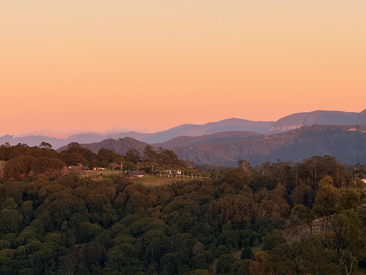 Pink dusk sky over layered hinterland ridges