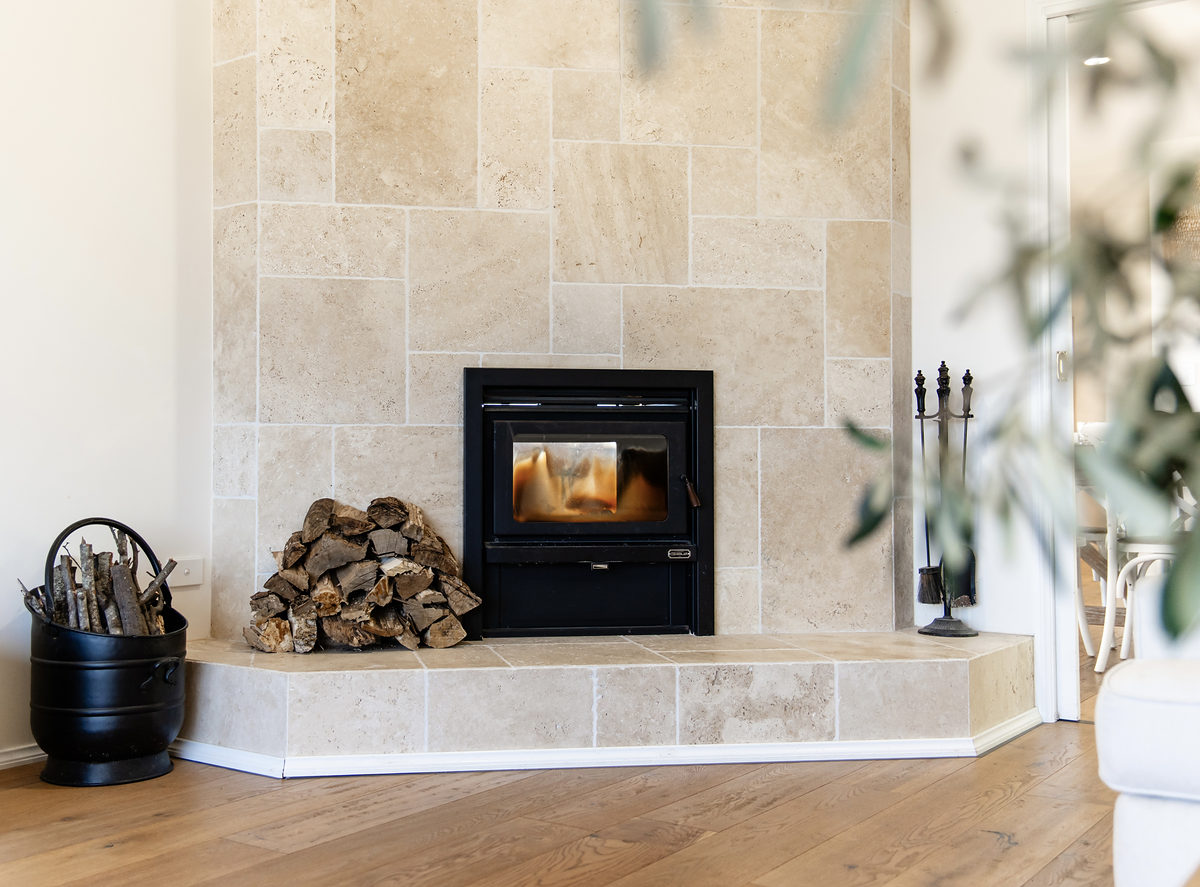 The indoor wood fireplace with stacked firewood